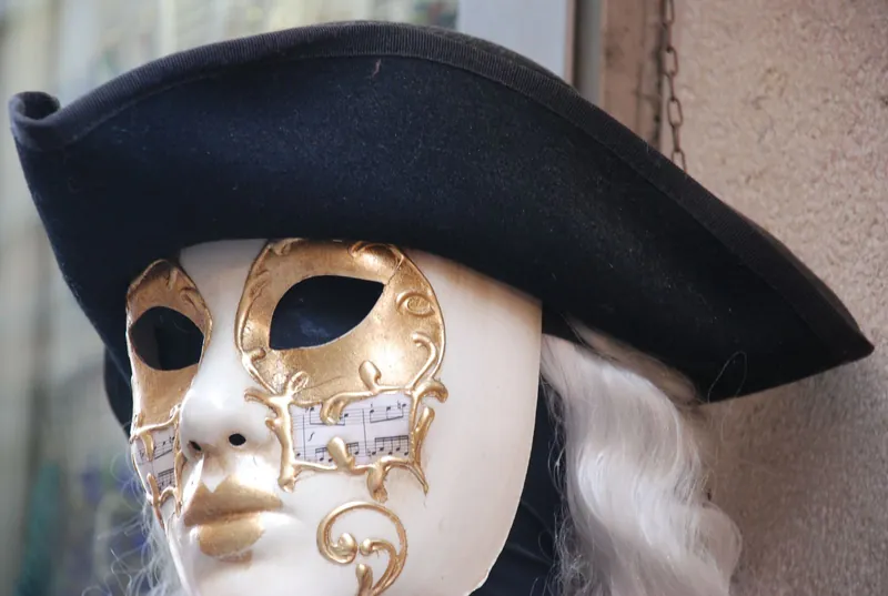 Golden Venetian mask with a tricorn hat, a highlight of carnival with kids in Venice