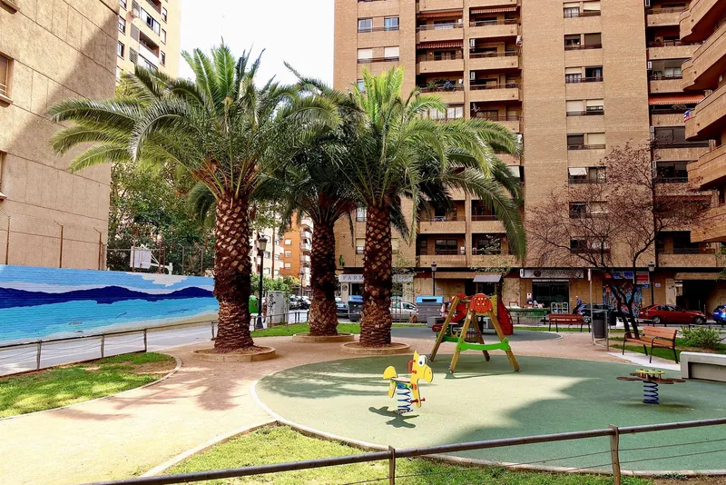 Neighbourhood playground under palm trees in Valencia, a city with some of the best playgrounds in Europe
