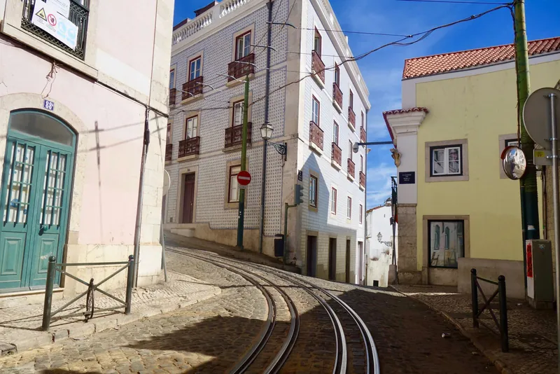 Tram tracks and tiled houses in Alfama, Lisbon, a favourite destination for city breaks with kids
