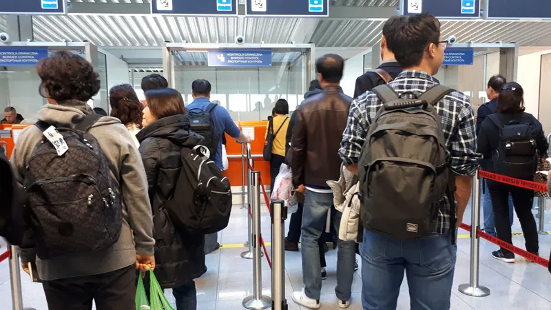 Travellers queuing at border control in Warsaw airport, where the new Entry/Exit System now registers non-EU visitors