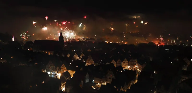 Fireworks over the old town of Tübingen at midnight, a highlight of New Year's Eve with kids