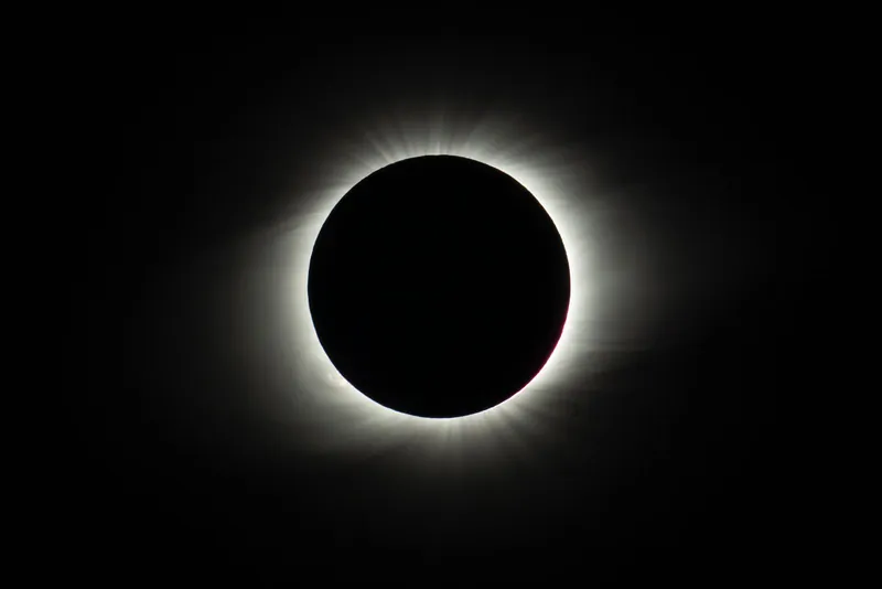 Total solar eclipse with the glowing corona around the dark Moon, an unforgettable solar eclipse with kids