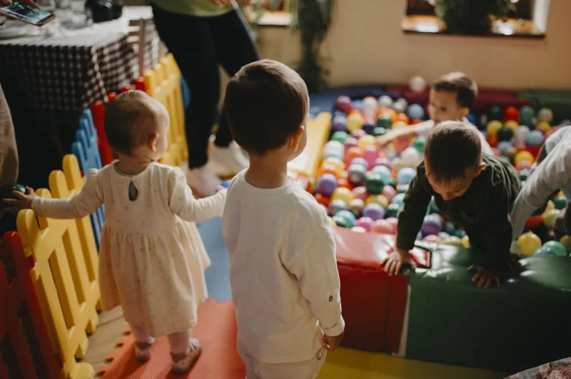 Toddlers by a colourful ball pit at one of the many soft play centres in the UK