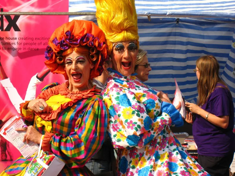 Two pantomime dames in colourful costumes and wigs, the stars of family pantomimes at Christmas