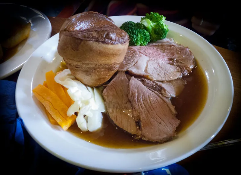 Roast lamb with a giant Yorkshire pudding, vegetables and gravy, a classic among family-friendly Sunday roasts